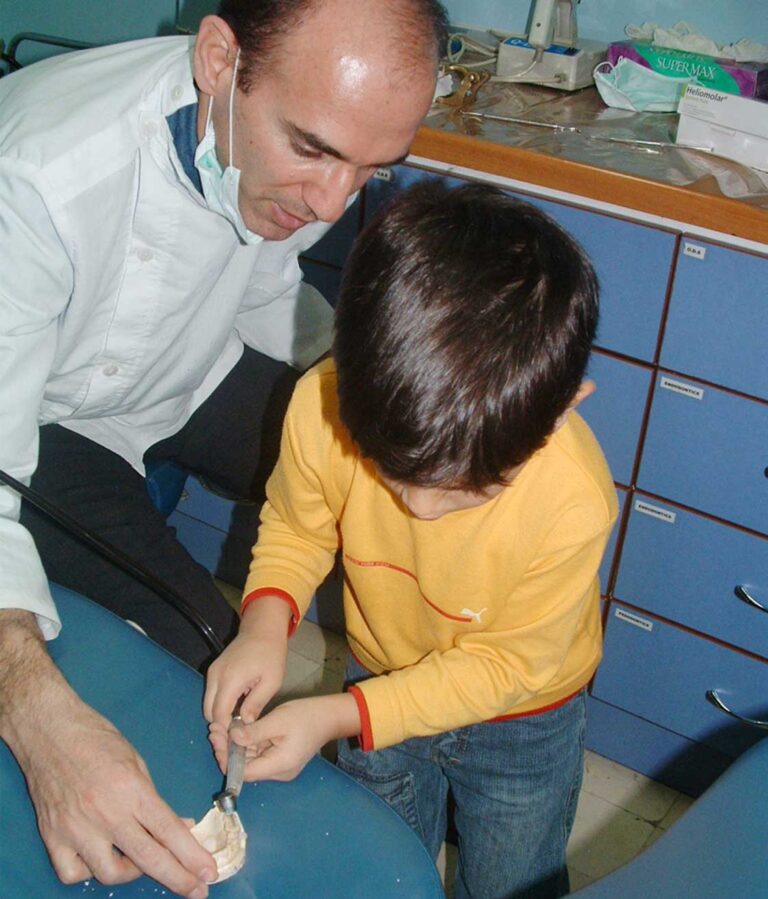 Dr. Hamid Tamimi helps his son to get involved in dental work.